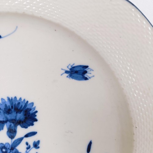 590 - An early 19th century blue and white plate, decorated flowers and insects