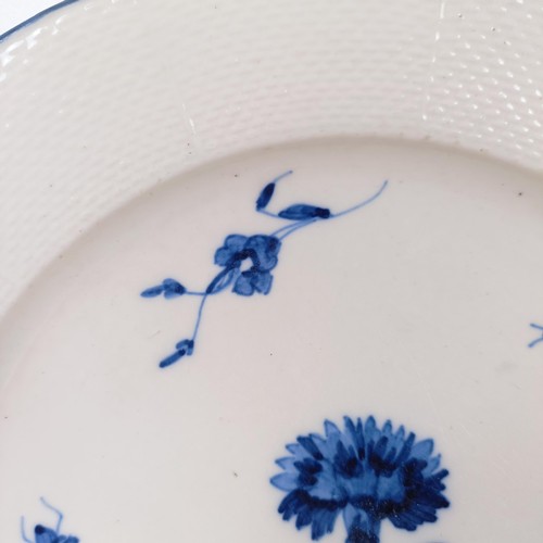 590 - An early 19th century blue and white plate, decorated flowers and insects