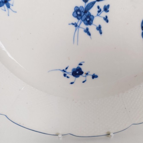 590 - An early 19th century blue and white plate, decorated flowers and insects