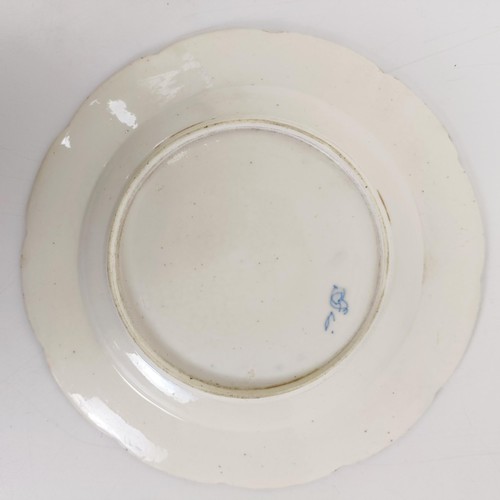 590 - An early 19th century blue and white plate, decorated flowers and insects