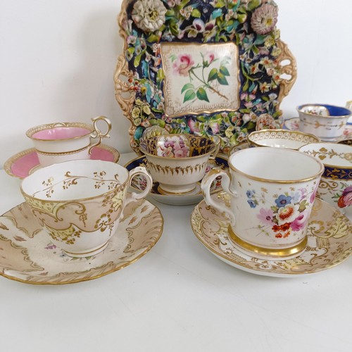 588 - A cabinet cup and saucer, assorted other cups and saucers, and a floral encrusted twin handle bowl (... 