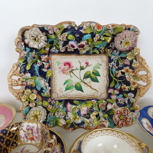 588 - A cabinet cup and saucer, assorted other cups and saucers, and a floral encrusted twin handle bowl (... 