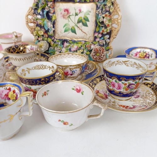 588 - A cabinet cup and saucer, assorted other cups and saucers, and a floral encrusted twin handle bowl (... 