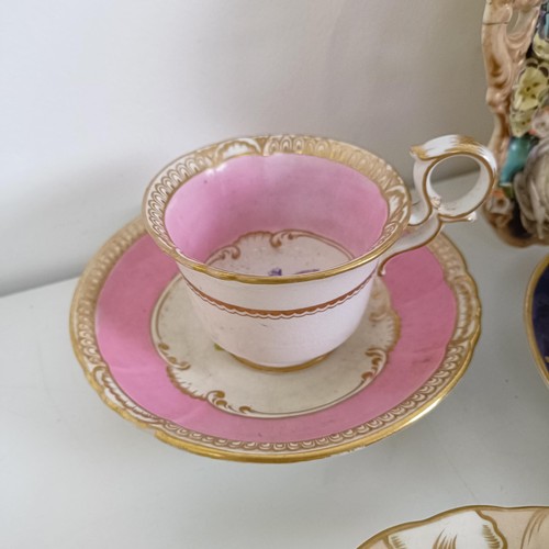 588 - A cabinet cup and saucer, assorted other cups and saucers, and a floral encrusted twin handle bowl (... 