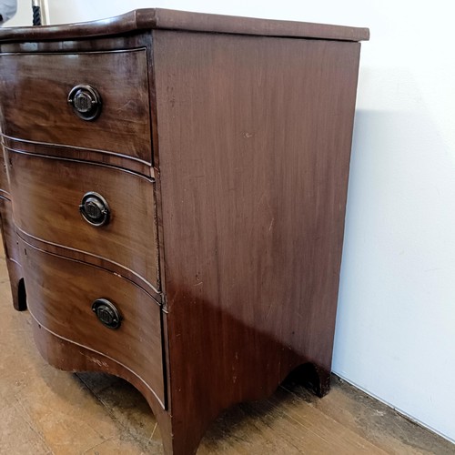 933 - A 19th century mahogany serpentine chest, having three drawers, 118 cm wide