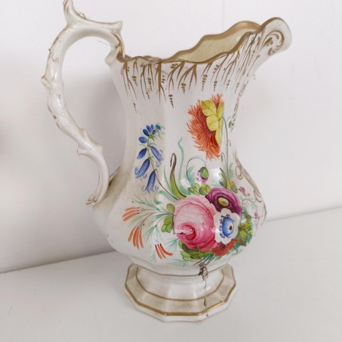 585 - A 19th century jug, decorated flowers, dated 1842, 23 cm high, another, 22 cm high, and another 23 c... 