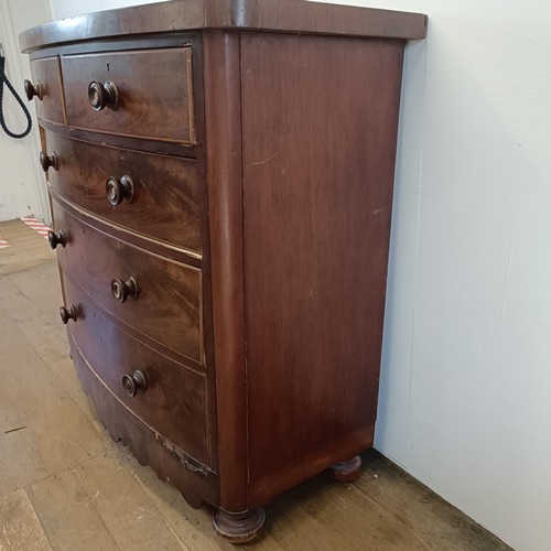 935 - A Victorian mahogany bow front chest, having two short and three long drawers, 126 cm wide