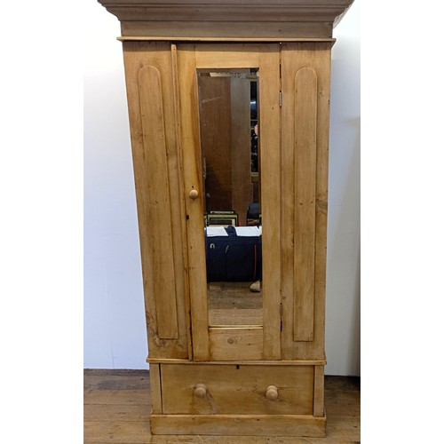 942 - A stripped pine wardrobe, with a mirrored door, 95 cm wide