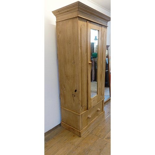 942 - A stripped pine wardrobe, with a mirrored door, 95 cm wide