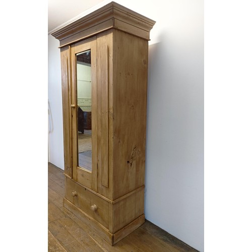 942 - A stripped pine wardrobe, with a mirrored door, 95 cm wide