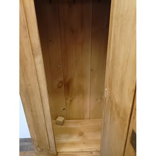 942 - A stripped pine wardrobe, with a mirrored door, 95 cm wide