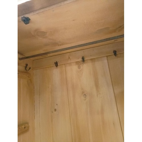 942 - A stripped pine wardrobe, with a mirrored door, 95 cm wide