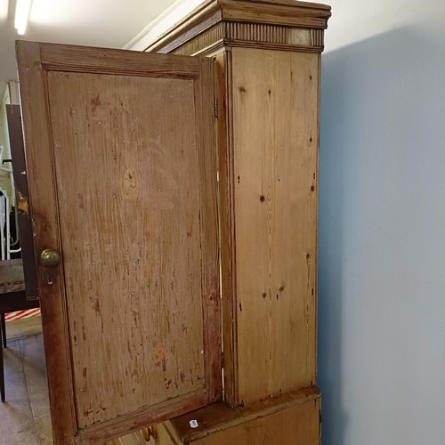 943 - A pine housekeepers style cabinet, the top having two cupboard doors, the base with three short and ... 