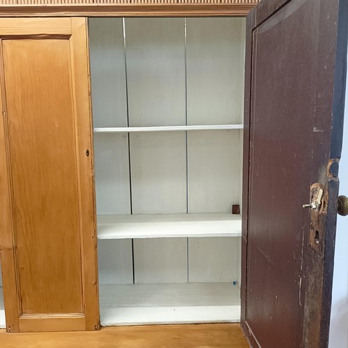 943 - A pine housekeepers style cabinet, the top having two cupboard doors, the base with three short and ... 