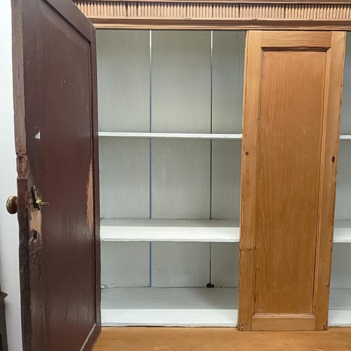 943 - A pine housekeepers style cabinet, the top having two cupboard doors, the base with three short and ... 