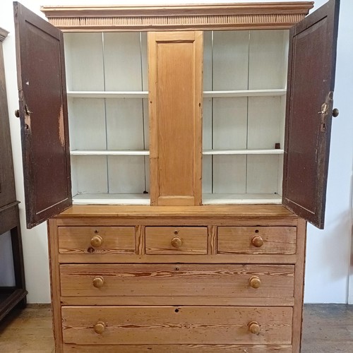 943 - A pine housekeepers style cabinet, the top having two cupboard doors, the base with three short and ... 