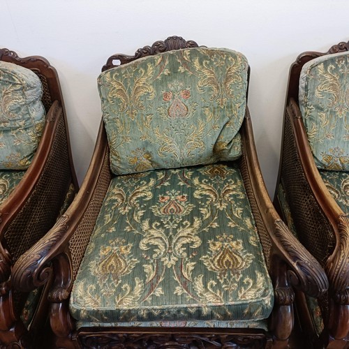 960 - A bergere suite, with a carved mahogany frame, double caned arms and back, some losses, comprising a... 