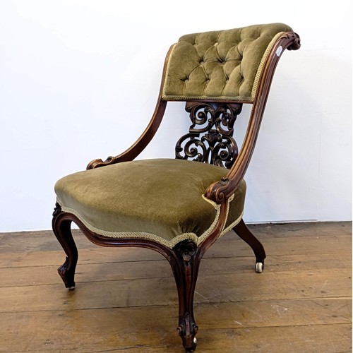 962 - A 19th century walnut framed nursing chair, with a carved pierced back