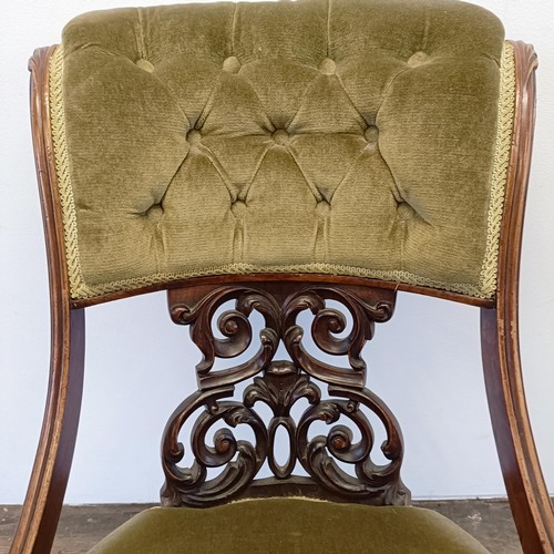 962 - A 19th century walnut framed nursing chair, with a carved pierced back