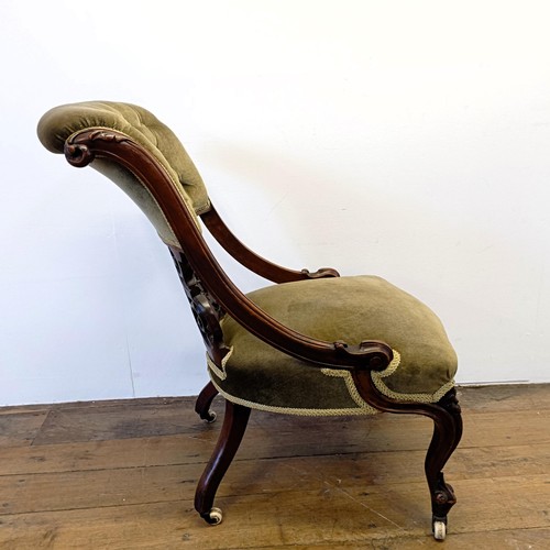 962 - A 19th century walnut framed nursing chair, with a carved pierced back