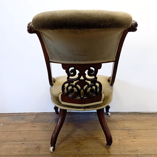 962 - A 19th century walnut framed nursing chair, with a carved pierced back