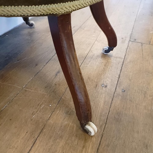 962 - A 19th century walnut framed nursing chair, with a carved pierced back