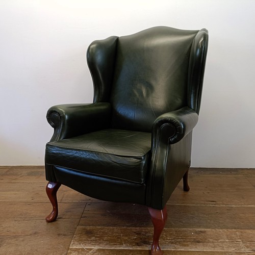 966 - A green leather wingback armchair