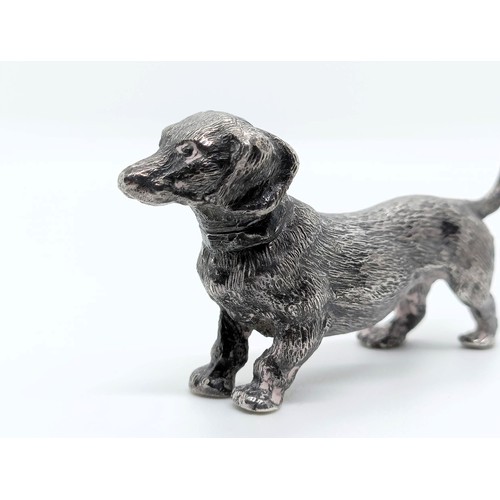 717 - A silver figure of a dachshund, London, 1972, 77g,  6 cm wide, and a continental silver figure of a ... 