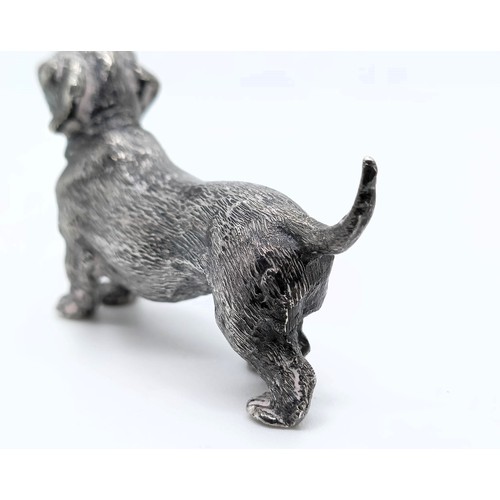 717 - A silver figure of a dachshund, London, 1972, 77g,  6 cm wide, and a continental silver figure of a ... 