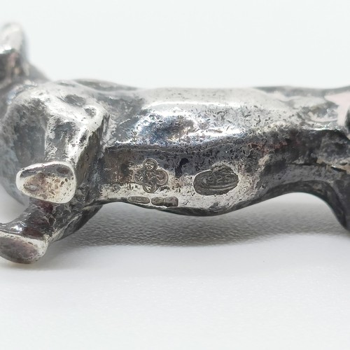 717 - A silver figure of a dachshund, London, 1972, 77g,  6 cm wide, and a continental silver figure of a ... 