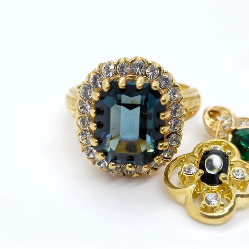 739 - A yellow coloured metal, blue and white stone dress ring, ring size R, a green and white stone penda... 