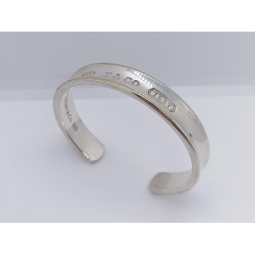 740 - A modern Tiffany & Co silver bangle, dated 1997