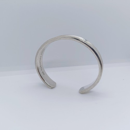 740 - A modern Tiffany & Co silver bangle, dated 1997