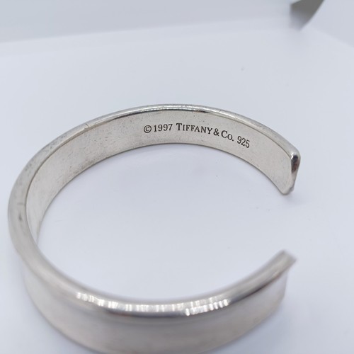 740 - A modern Tiffany & Co silver bangle, dated 1997