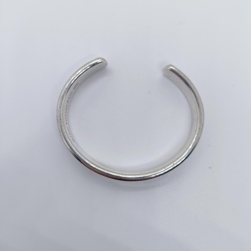 740 - A modern Tiffany & Co silver bangle, dated 1997