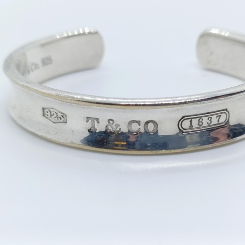 740 - A modern Tiffany & Co silver bangle, dated 1997