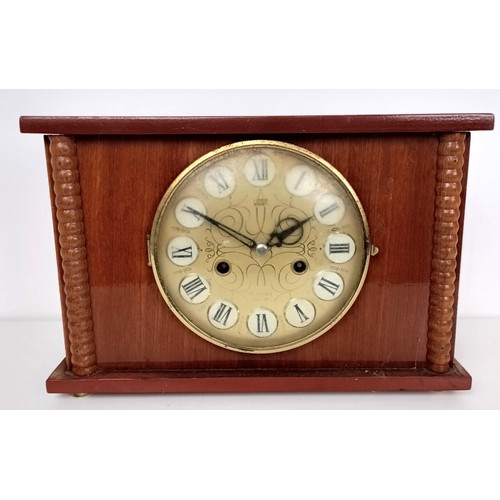 863 - A mantel clock, in a slate case, 27 cm wide, and four other clocks (5)