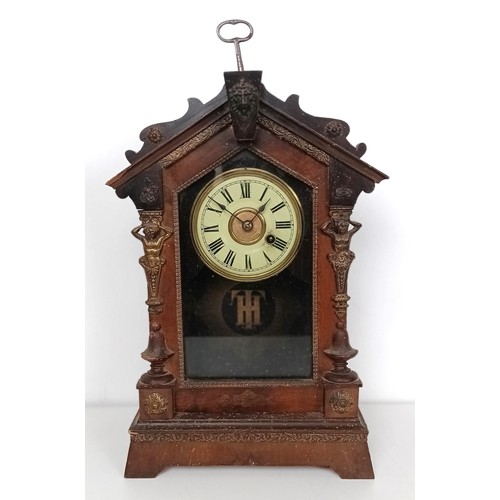 863 - A mantel clock, in a slate case, 27 cm wide, and four other clocks (5)