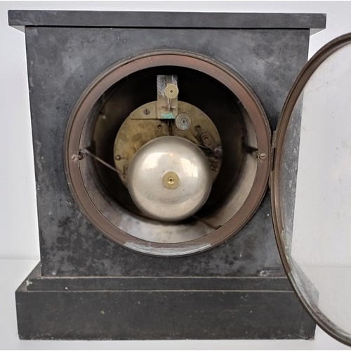 863 - A mantel clock, in a slate case, 27 cm wide, and four other clocks (5)