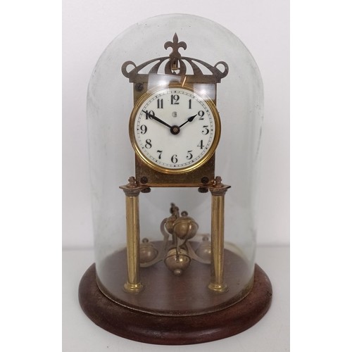 863 - A mantel clock, in a slate case, 27 cm wide, and four other clocks (5)