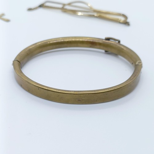 746 - A rolled gold bangle, and assorted other jewellery