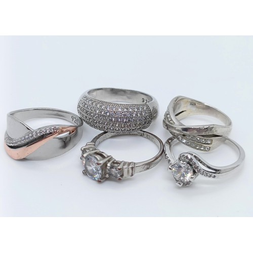 747 - A silver gem set dress ring, and four others (5)