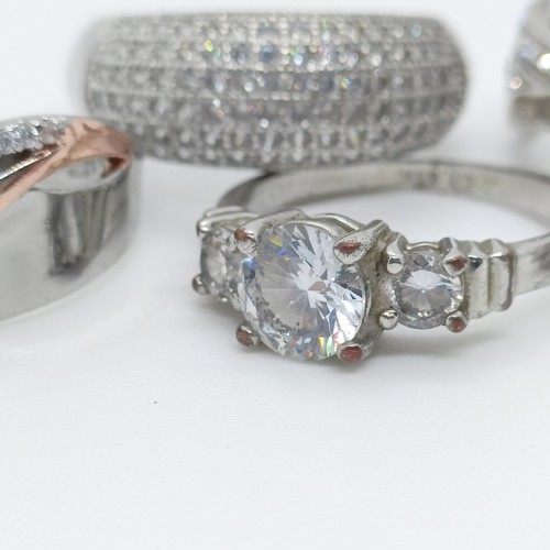 747 - A silver gem set dress ring, and four others (5)