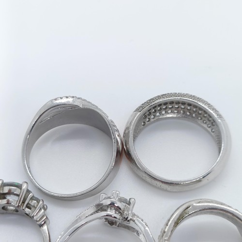 747 - A silver gem set dress ring, and four others (5)