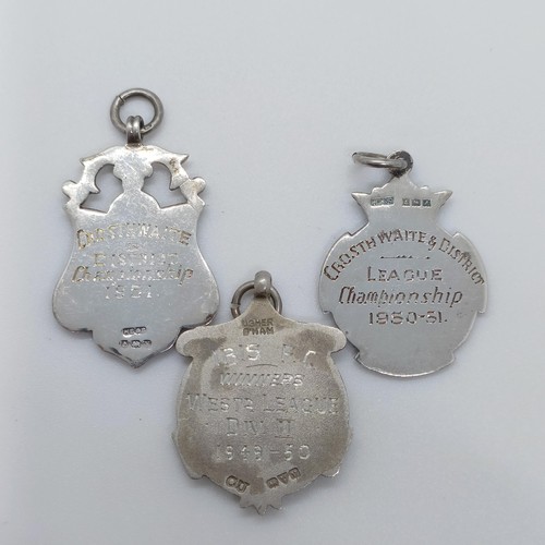 763 - A silver and yellow coloured metal badge, and two others (3)