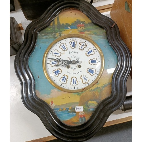 874 - A mantel clock, in a slate case, 30 cm wide, a glass dome, and a French wall clock