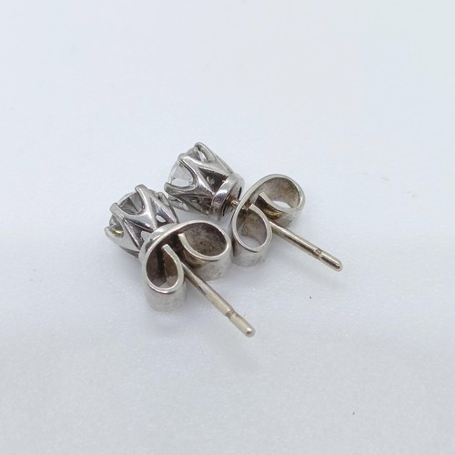 789 - A pair of diamond solitaire stud earrings