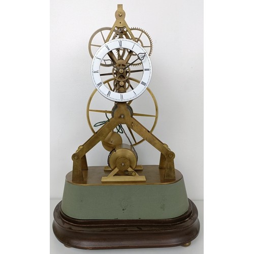 883 - A skeleton clock, with an enamel dial fitted a single fusee movement, on an ebonized base under a gl... 