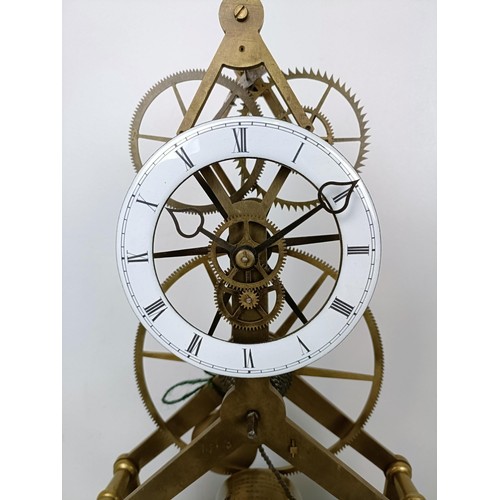 883 - A skeleton clock, with an enamel dial fitted a single fusee movement, on an ebonized base under a gl... 