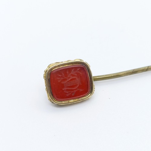 792 - A yellow coloured metal and red stone seal fob, converted to a stick pin